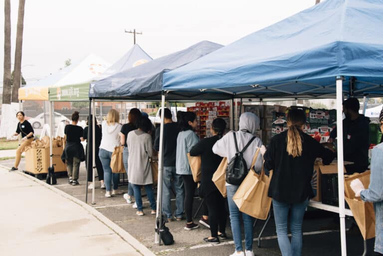 People lining up at food distribution